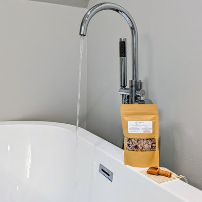 Wyldflower Apothecary Botanical Bath Soak beside a running bath